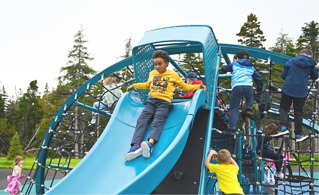 Child going down blue slide