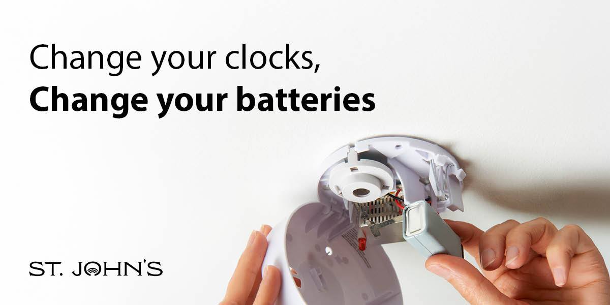 white background with someone changing the batteries in a smoke detector with black text "change your clocks, change your batteries"