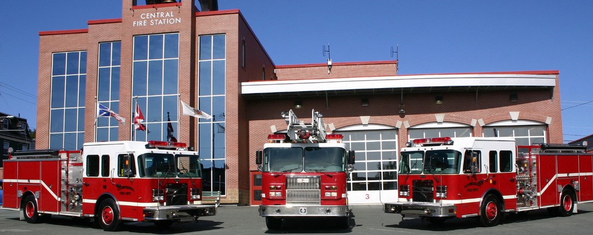 three fire engines parked in the foreground with Central Fire Station in the background