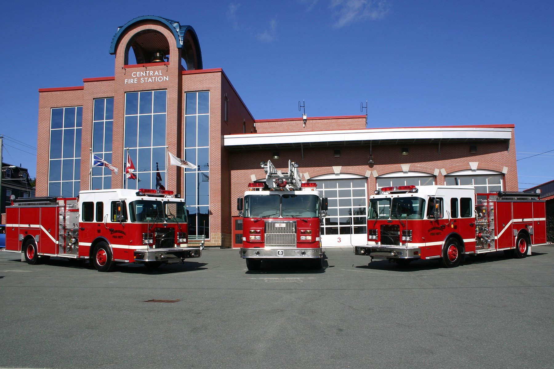 exterior of Central Fire station with three fire engines at large bay doors