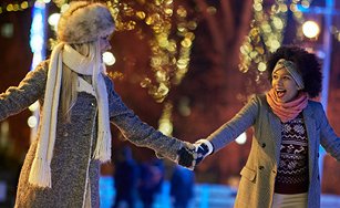 Image of two people holding hands dressed in winter clothing