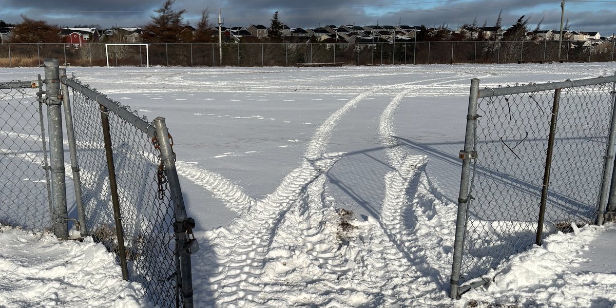 broken gate at McNiven soccer field with atv tracks on the field. 