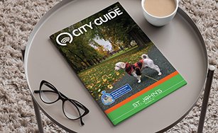 Fall 2024 City Guide on a tray with a cup of coffee and a pair of glasses. 