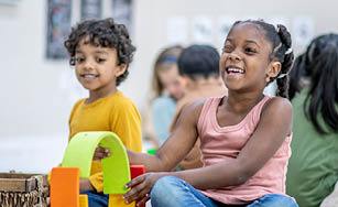 children playing and laughing, includes balloons and text that says National Child Day. 